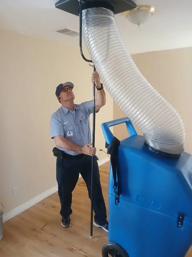 Furnace Tune-Up technician using HEPA equipment in Universal City